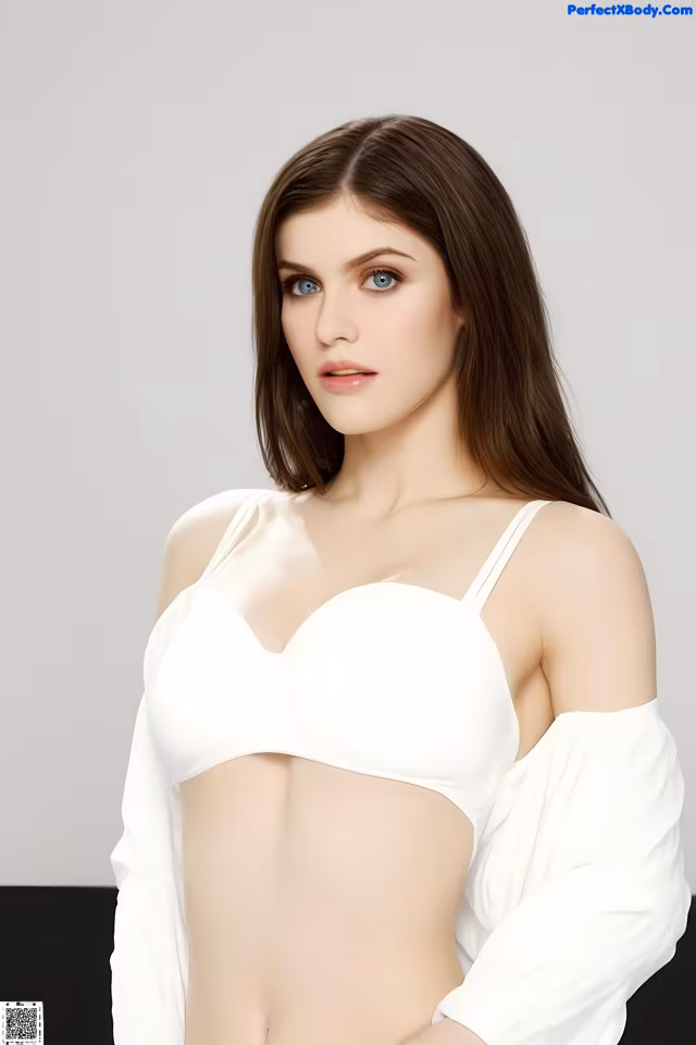 A woman in a white top is posing for a picture.
