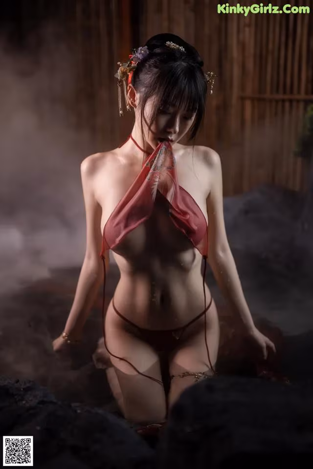 A woman in a red bikini sitting in a hot tub.