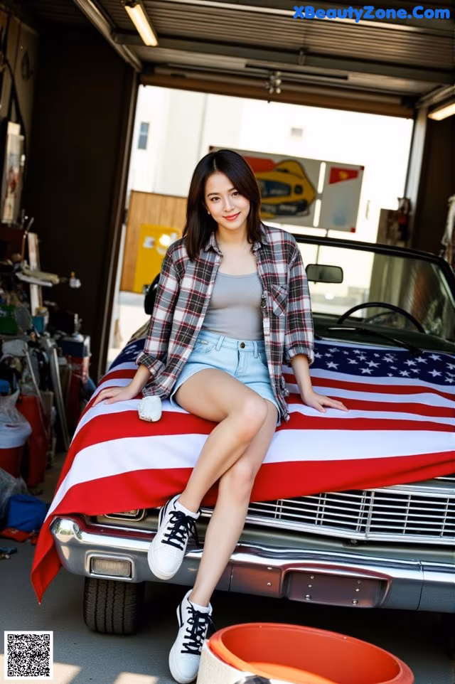 A woman sitting on top of a car covered in an American flag.
