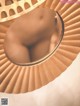 A close up of a paper fan with a hole in it.
