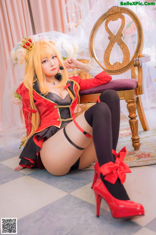 A woman in a red and black outfit sitting on a chair.