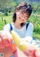 A woman holding a yellow object in her hand.