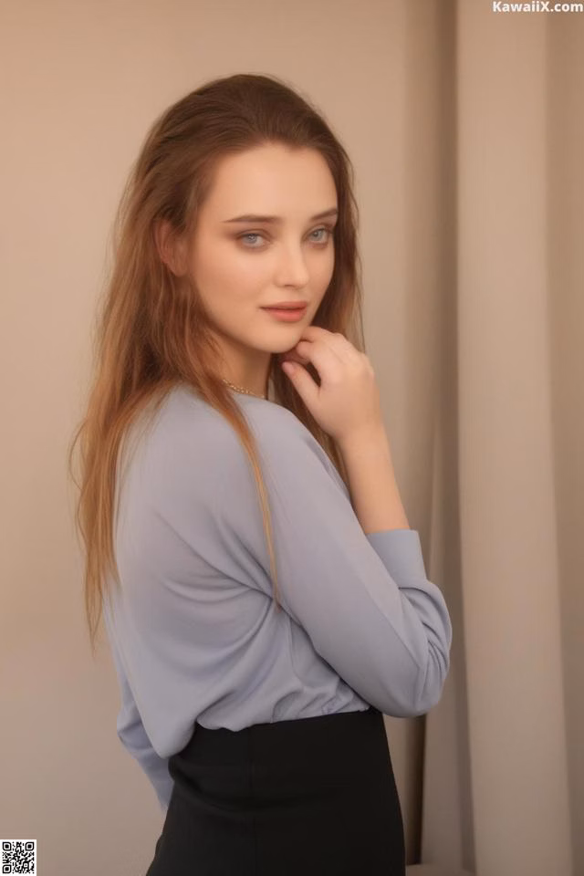 A woman in a blue shirt and black skirt posing for a picture.