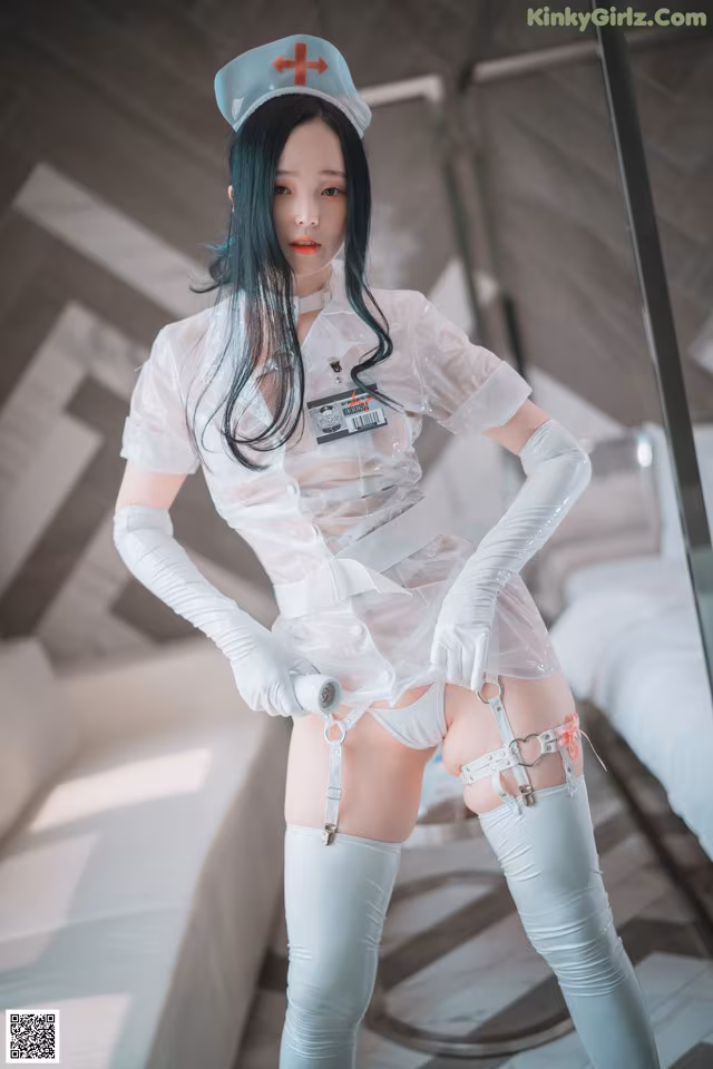 A woman dressed as a nurse posing for a picture.